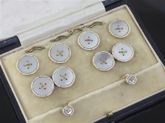 A cased early/mid 20th century 9ct gold and mother of pearl eight piece dress stud set.